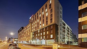 A multi-story hotel with a modern design, featuring a prominent 'Comfort' sign. - Micro Apartments Kazou Residence (Warsaw)