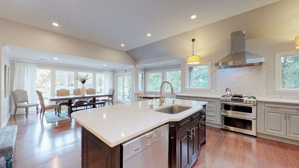 A spacious kitchen with a large island, built-in oven, and ample natural light from large windows. - Beautiful home on the 11-mile lagoon system with a large private pool! (Hilton Head)