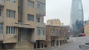 A street with buildings, including a modern glass skyscraper and older structures. - Baku Sea View Hotel (Baku)