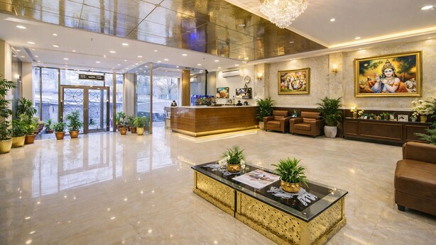 A spacious lobby with a reception desk, seating area, and decorative plants. - The D'Capitol Delhi, International Airport (New Delhi)
