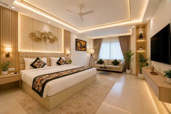 A modern bedroom with a large bed, a sofa, a TV, and a ceiling fan. - The D'Capitol Delhi, International Airport (New Delhi)