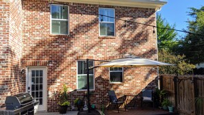 A brick house with a patio, outdoor furniture, and a grill. - Master's Rental - House, Walking distance to Smokehouse BBQ and a coffee shop (Augusta)