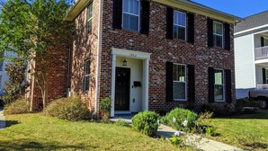 A two-story brick building with a front door labeled "1902". - Master's Rental - House, Walking distance to Smokehouse BBQ and a coffee shop (Augusta)