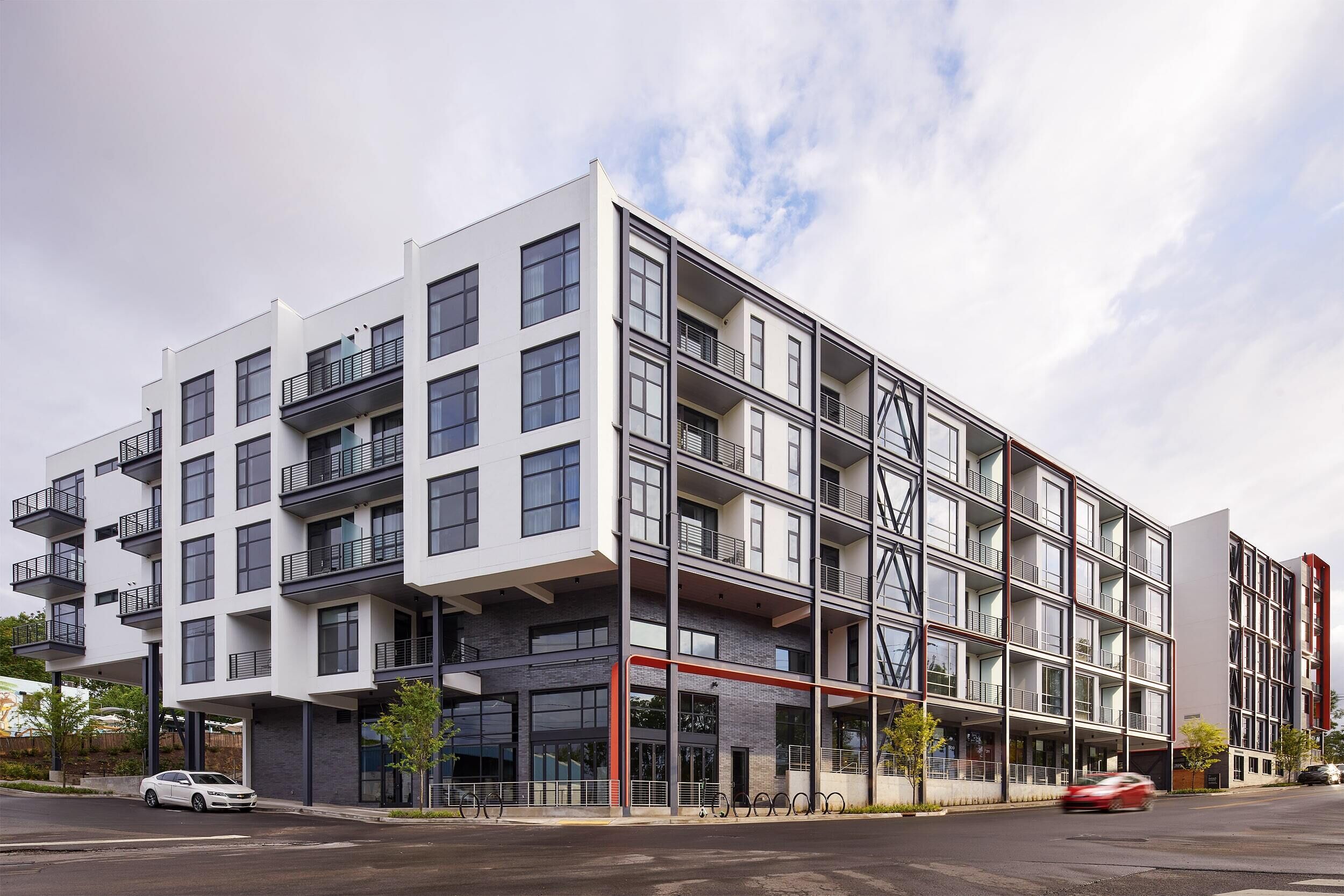 A multi-story building with balconies, large windows, and a modern architectural design.