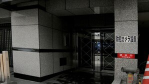 A building entrance with a sign reading "Grand Court - Nishi". - Grand Court Namba 402 (Osaka)