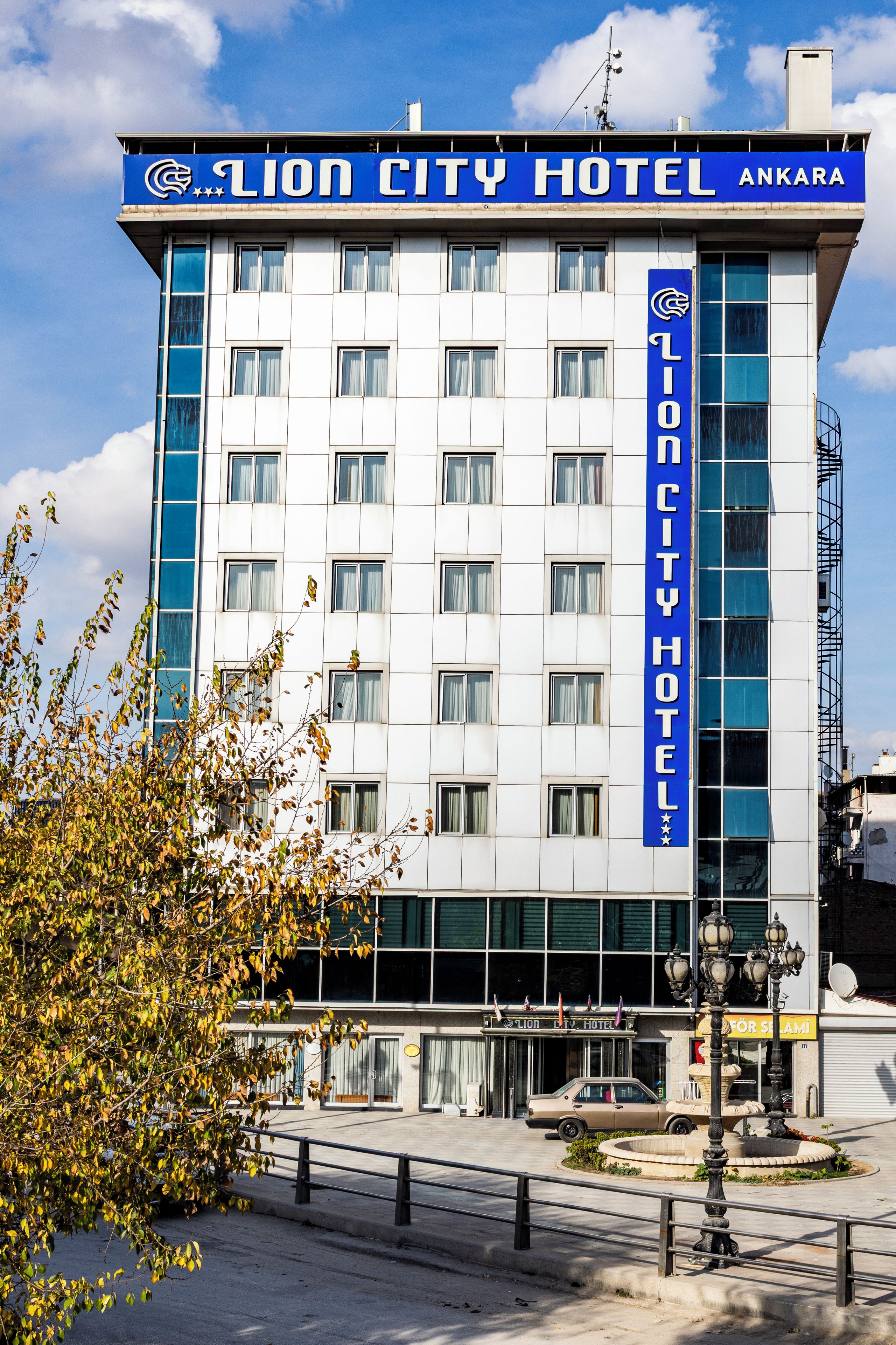 A hotel building with a prominent sign reading 'Lion City Hotel Ankara'.