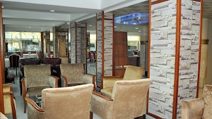 A spacious lobby with comfortable seating, a reception area, and a view of the dining area. - Lion City Hotel Ankara (Ankara)