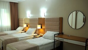 A hotel room with two single beds, a desk, a mirror, and bedside lamps. - Lion City Hotel Ankara (Ankara)