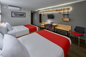 A hotel room with two beds, a desk, a chair, a TV, and a wall-mounted shelf. - City Express by Marriott Guaymas (Guaymas)