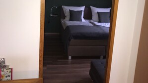 A bedroom with a bed, bedside table, and two wall-mounted lamps. - Fantastic vacation apartment "Waldhonig" (St. Englmar)