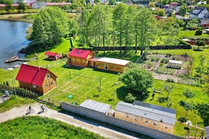 A residential area with a house, a dock, and a garden.