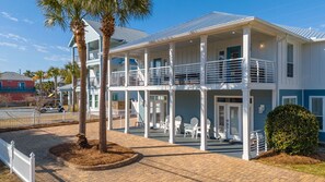 A two-story beachfront property with a covered patio, outdoor seating, and a fenced driveway. - ☀️Crystal Beach Sandcastle – Private Pool Duplex, Sleeps Large Groups in Destin☀ (Destin)