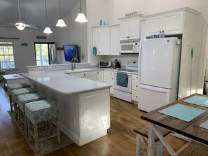Enjoy meals in the kitchen with a central island, sink, and microwave, and dine at the wooden table with benches.