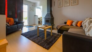 A living room with a fireplace, two sofas, a coffee table, and a rug. - Apartments Brankica (Dramalj)