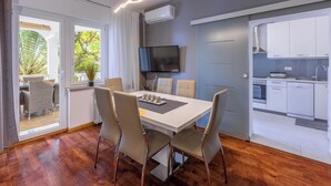 A modern kitchen with white cabinets, a built-in oven, and a dishwasher. - Apartment Villa Zdenka (Crikvenica)