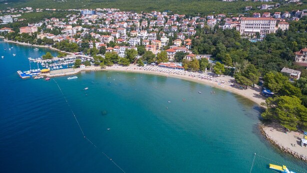 An aerial view of a coastal town with a marina, beach, and residential buildings. - Apartment Weiny (Crikvenica)