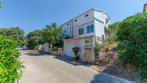 A two-story white building with a stone facade and a red-tiled roof. - Apartment Ljubica (Zavalatica)