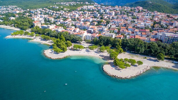 An aerial view of a coastal town with buildings, beaches, and clear blue waters. - Apartments Villa 7 (Crikvenica)