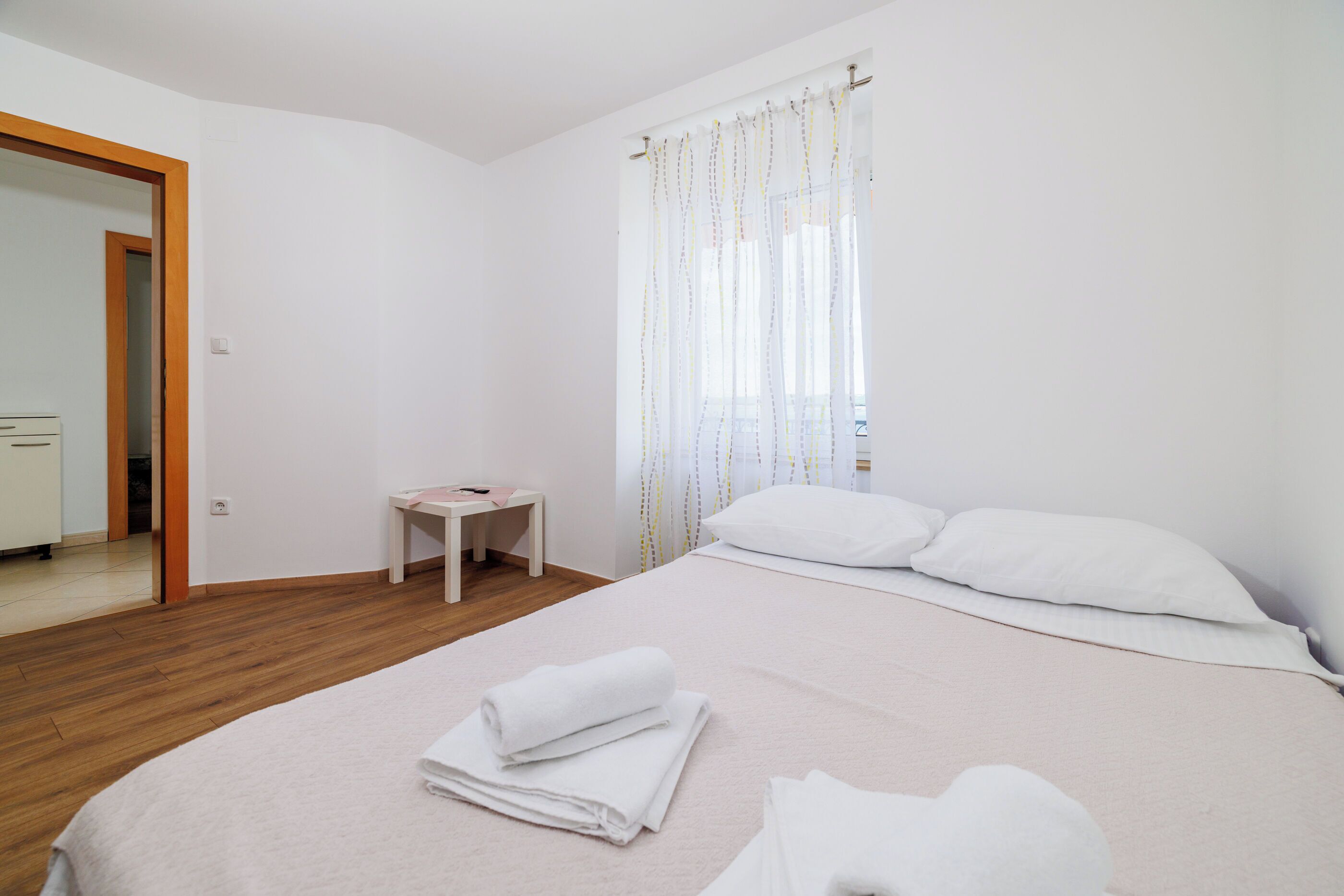 Ein Hotelzimmer mit einem Bett, einem kleinen Tisch, einem Stuhl und einem Spiegel.