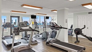 A gym with treadmills, elliptical machines, and stationary bikes. - 11th floor paradise! (Panama City Beach)