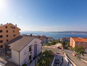A coastal residential area with buildings overlooking the sea. - Apartments Marko (Crikvenica)
