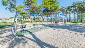 A playground with swings, slides, and climbing structures. - Apartment Seka (Sabunike)