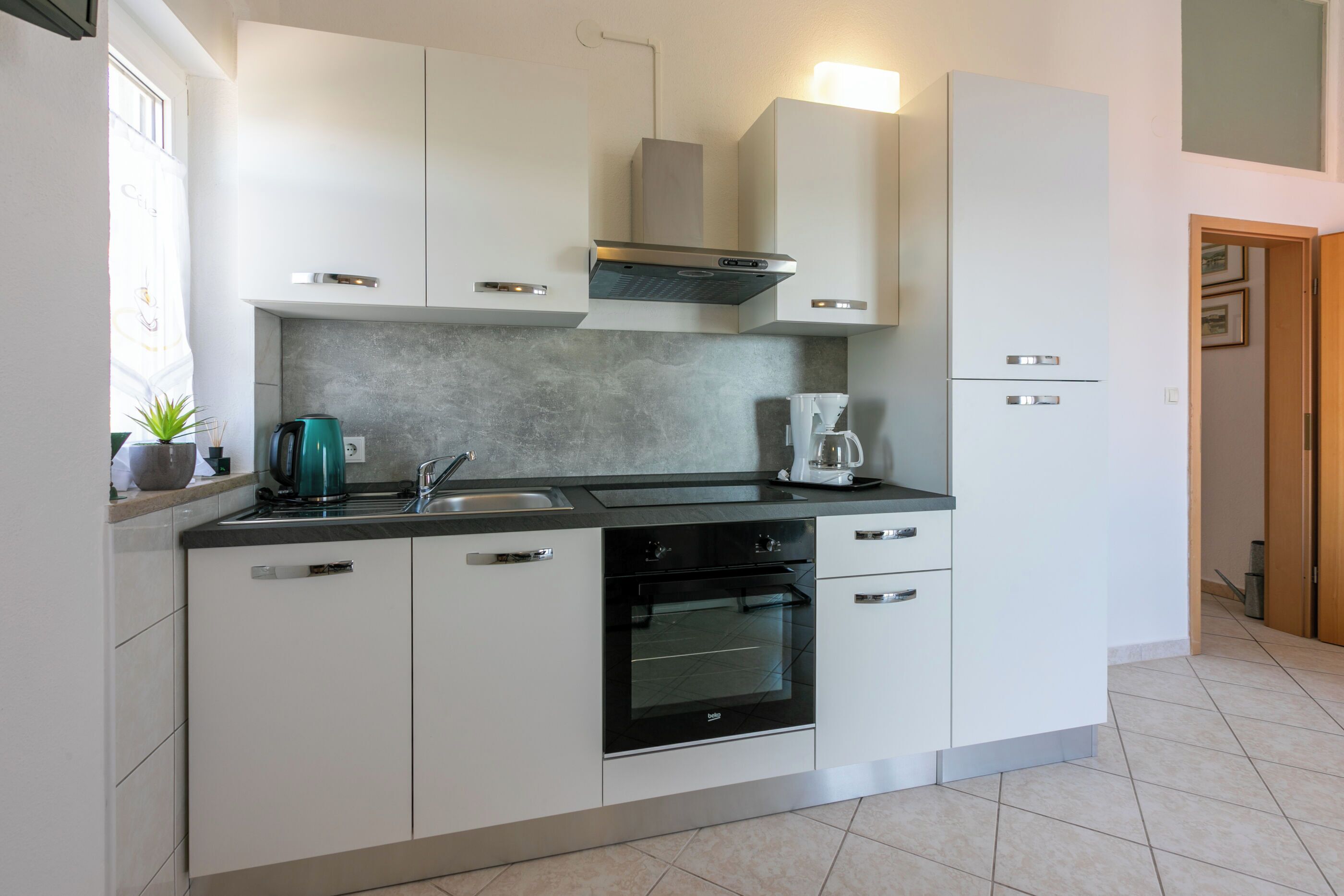 Apartment (A4) | Private kitchen | Fridge, stovetop, electric kettle, cookware/dishes/utensils