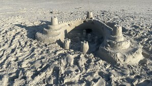 A sandy beach with a large sandcastle featuring multiple towers and a moat. - 8/27- 9/4  open  5 STARS  Great ratings- Hidden Gem Great Lagoon/Golf/pool view (Hilton Head Island)