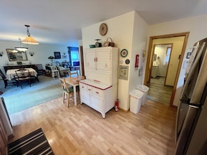 Cozy living space with a central kitchen, dining area, and comfortable seating for relaxation.