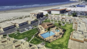 A coastal hotel with a swimming pool, a parking lot, and a view of the beach and ocean. - Pismo Shores Paradise #119 - 50yds to beach access (Pismo Beach)