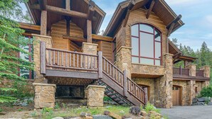 A log cabin with a stone foundation, wooden balconies, and a stone staircase. - Hilltop Breck Home: Hot Tub, Views & Walk to Town (Breckenridge)