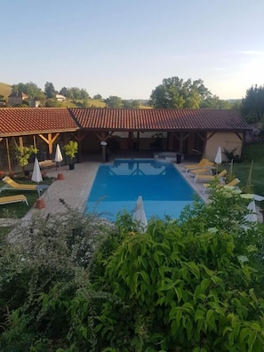 Seasonal outdoor pool, pool umbrellas, pool loungers