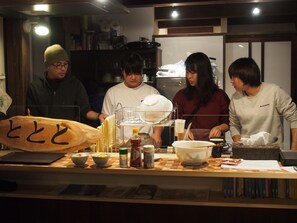 A group of people in a kitchen preparing food.