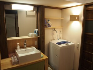 A bathroom with a sink, mirror, and a water heater.