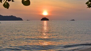 A calm sea at sunset with a distant island. - AVI Pangkor Beach Resort (Pangkor Island)