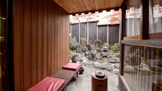 A wooden deck with benches and a stone lantern. - Azuma Ryokan (Kitakata)