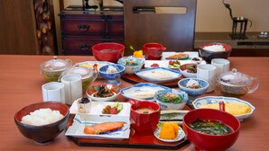A traditional Japanese meal setup with various dishes and bowls on a table. - Azuma Ryokan (Kitakata)