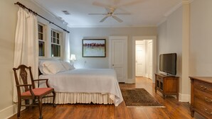 A bedroom with a bed, a chair, a television, and a ceiling fan. - 3BR 2BA Dynamite Cooper Young Craftsman 2 blocks from Cooper Young intersection! (Memphis)