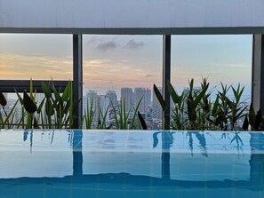 Outdoor pool, open 8:30 AM to 10:30 AM, pool umbrellas, pool loungers