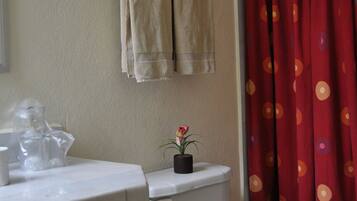 A bathroom with a toilet, sink, and a towel rack.
