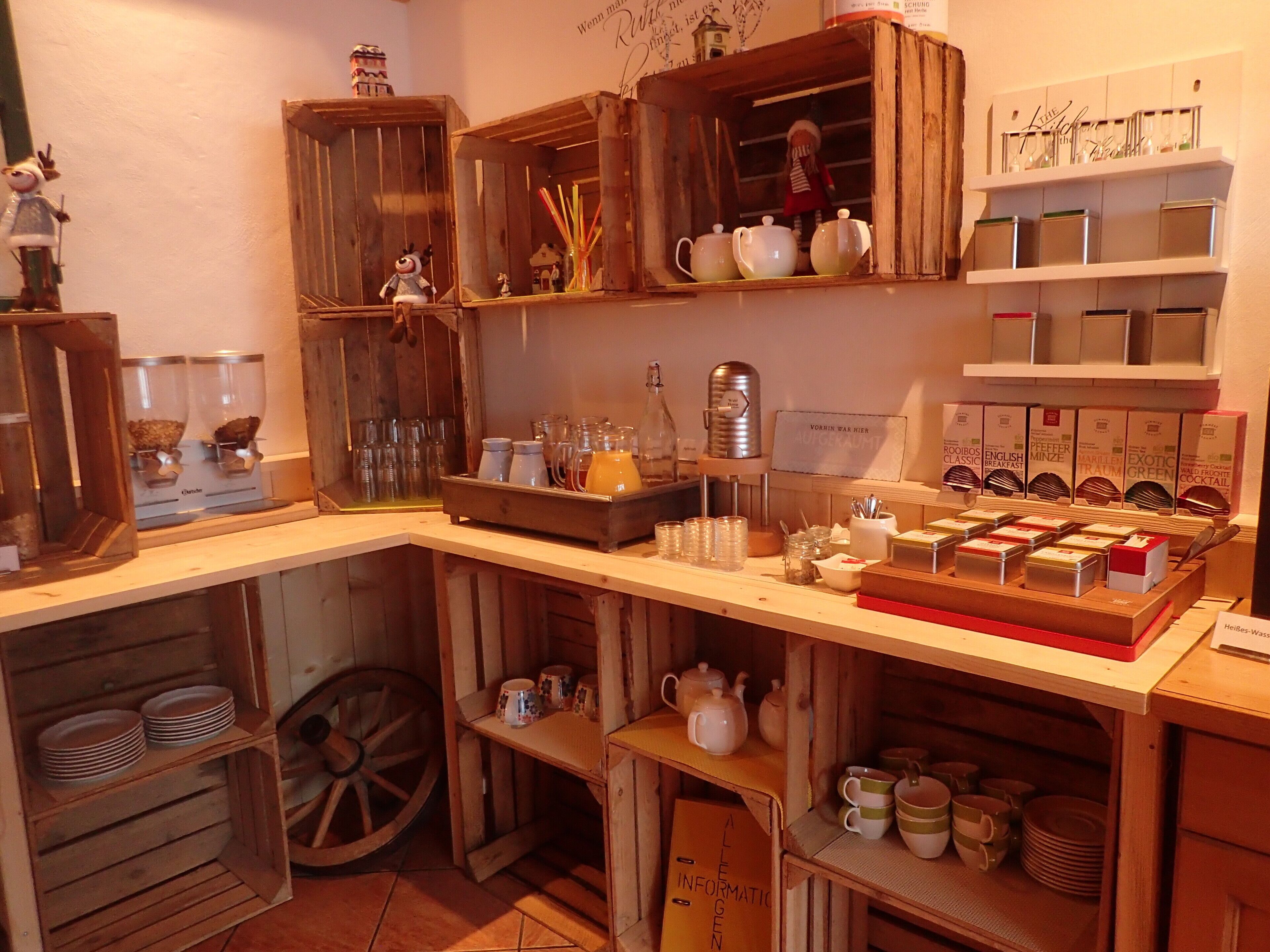 A cozy, rustic kitchen with wooden cabinets, a coffee machine, and various kitchenware.