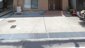 A two-story building with a flat roof, large windows, and a visible air conditioning unit. - Utatei Villa (Takayama)
