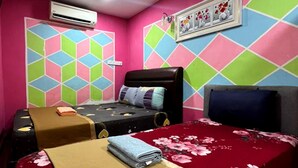 A room with two beds, colorful geometric wall patterns, an air conditioning unit, and a framed picture on the wall. - De Glory Hotel USJ 21 (Subang Jaya)