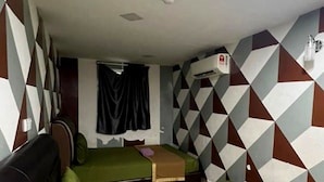 A compact room with two beds, a sofa, and a window with curtains. - De Glory Hotel USJ 21 (Subang Jaya)