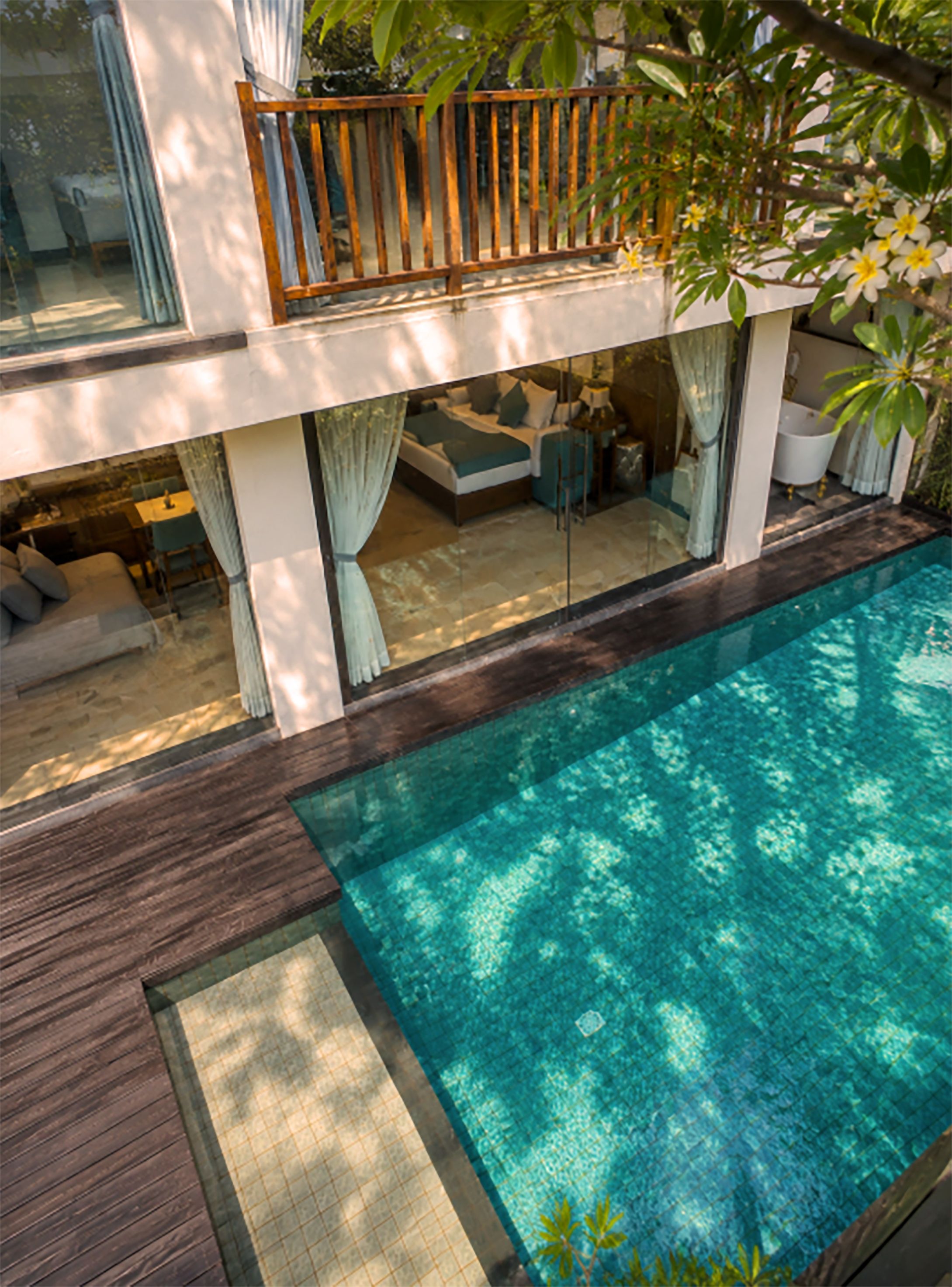 A modern house with a swimming pool, a balcony, and a garden.