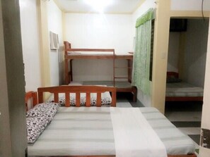 A small, compact room with bunk beds and a single bed. - Coffee Swings Lodging House (Vigan)