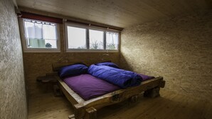 A wooden bed in a room with a window and a view of the outside. - Steigmatt Bauernhof - Erlebnis (Oberriet)