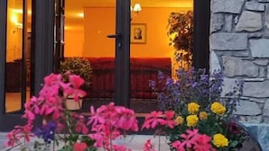 A stone facade with a wooden door leading to an interior with warm lighting. - Hotel Ransol (Ransol)
