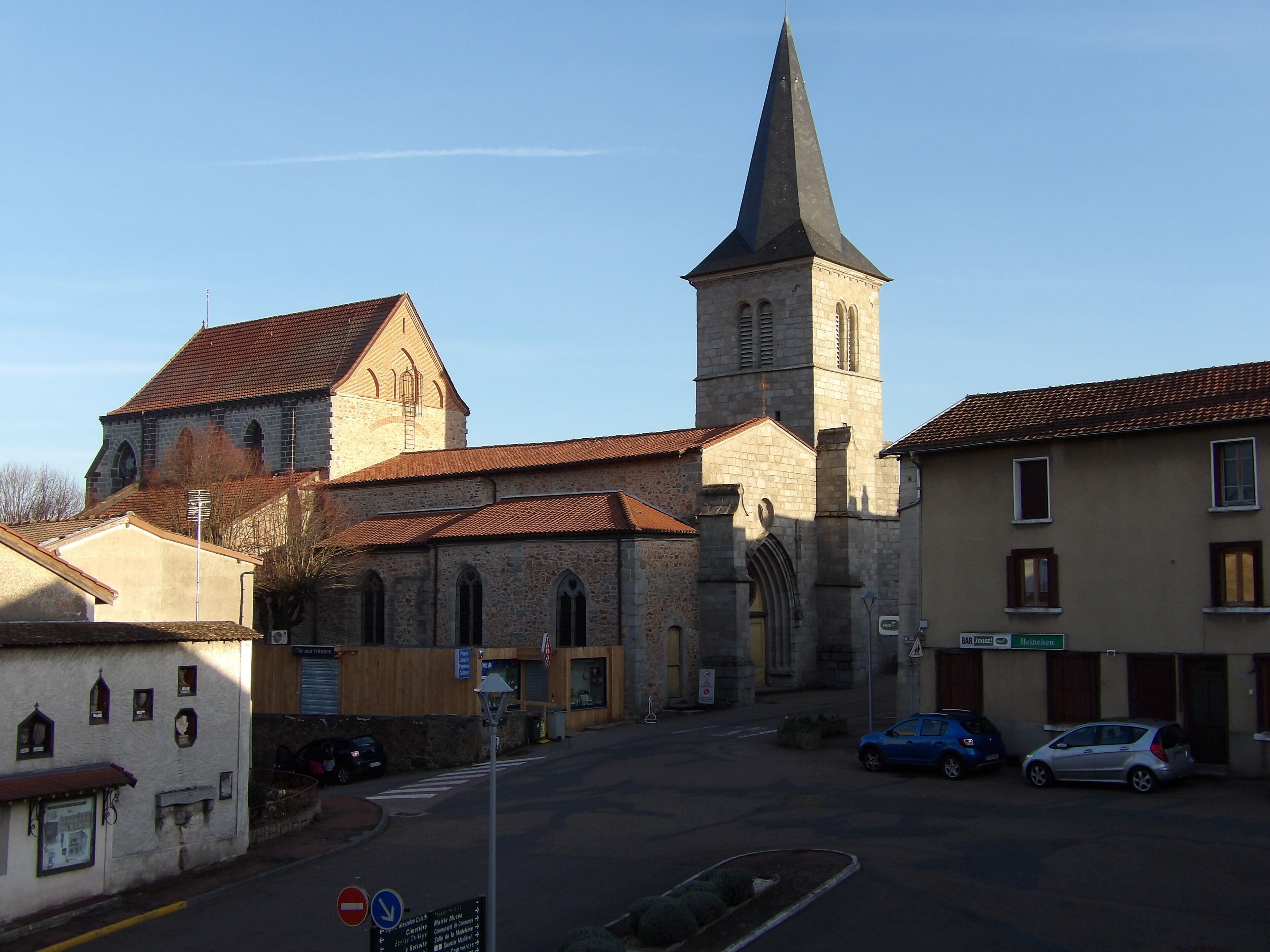 A church with a tall steeple and a traditional stone facade.