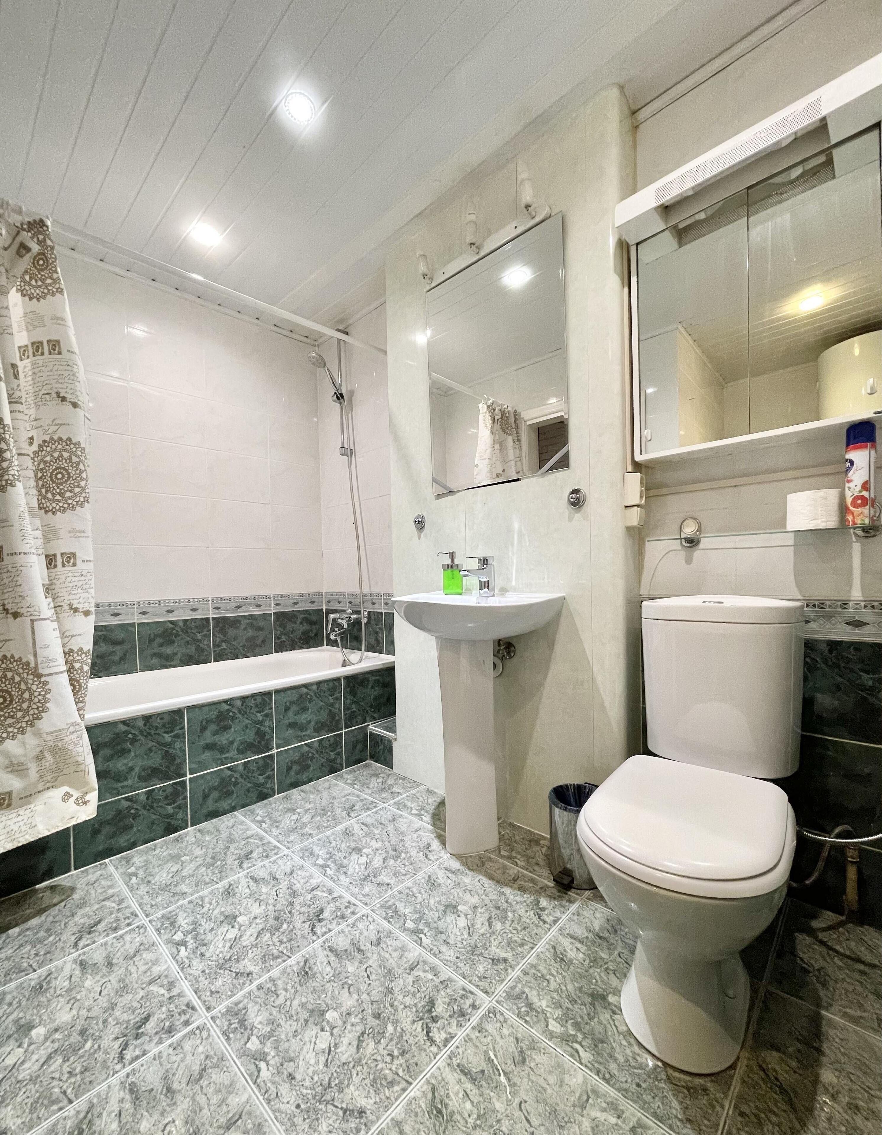 A bathroom with a bathtub, a sink, a toilet, and a shower.